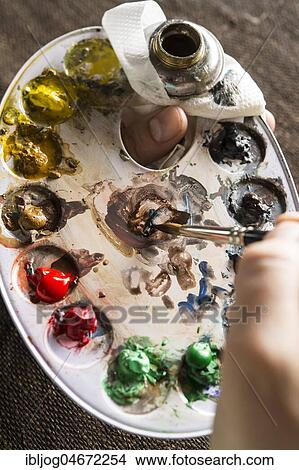 Picture - Restoration studio, restorer, hand mixes the colour for linen with brush and colour palette, Munich, Bavaria, Germany, Europe. Fotosearch