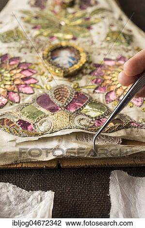 Restoration studio, restorer, hand checks artistically embroidered silk cloth torn open with tweezers, Munich, Bavaria, Germany, Europe View Large Photo Image Stock Image - Restoration studio, restorer, hand checks artistically embroidered silk cloth torn open with tweezers, Munich, Bavaria, Germany, Europe. Fotosearch