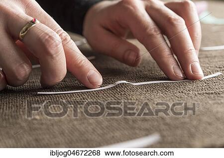 Restoration studio, restorer, hand marking seams for finished support fabric on lent scarf with paper strips, Munich, Bavaria, Germany, Europe View Large Photo Image Stock Photo - Restoration studio, restorer, hand marking seams for finished support fabric on lent scarf with paper strips, Munich, Bavaria, Germany, Europe. Fotosearch