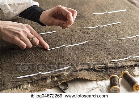 Restoration studio, restorer, hand marking seams for finished support fabric on lent scarf with paper strips, Munich, Bavaria, Germany, Europe View Large Photo Image Stock Photo - Restoration studio, restorer, hand marking seams for finished support fabric on lent scarf with paper strips, Munich, Bavaria, Germany, Europe. Fotosearch
