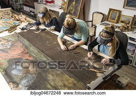 Stock Photo - Restoration studio, women, restorers restore lent scarf on worktable in Atelier, Munich, Bavaria, Germany, Europe. Fotosearch
