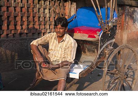 Rickshaw driver sitting and waiting, Chowringhee, Calcutta, Kolkata, West Bengal, India, South Asia, Asia View Large Photo Image Picture - Rickshaw driver sitting and waiting, Chowringhee, Calcutta, Kolkata, West Bengal, India, South Asia, Asia. Fotosearch