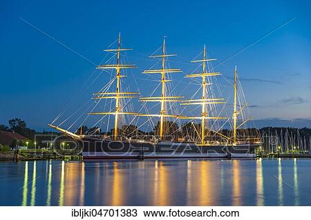 Stock Image - River Trave with the four-masted barque Passat, blue hour, Travemünde, Baltic Sea, Schleswig-Holstein, Germany, Europe. Fotosearch