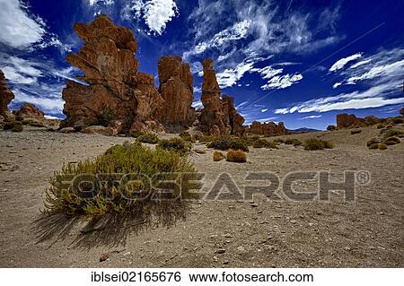 Stock Photograph - Rock formations against a blue cloudy sky, Uyuni, Bolivia, South America. Fotosearch