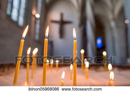 Stock Photograph - Sacrificial candles in front of the Imervard Cross, St. Blasii Cathedral Church, Brunswick, Lower Saxony, Germany, Europe. Fotosearch
