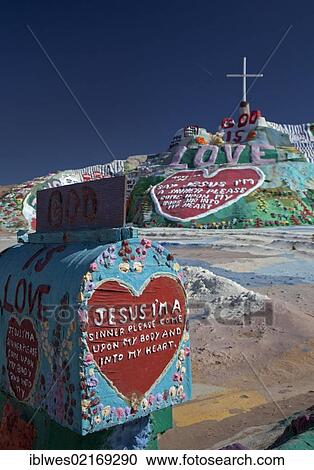 Stock Image - Salvation Mountain, a desert hillside covered with religious messages, created by Leonard Knight, Niland, California, USA, North America. Fotosearch