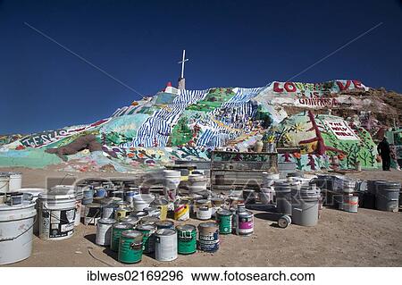 Salvation Mountain, a desert hillside covered with religious messages, created by Leonard Knight, paint used in decorating the mountain is in the foreground, Niland, California, USA, North America View Large Photo Image Stock Photograph - Salvation Mountain, a desert hillside covered with religious messages, created by Leonard Knight, paint used in decorating the mountain is in the foreground, Niland, California, USA, North America. Fotosearch