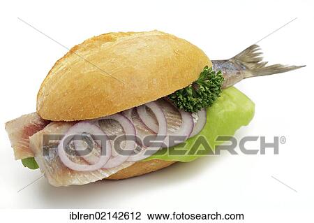 Stock Image - Sandwich with fresh soused herring and onion rings. Fotosearch