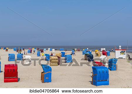 Sandy beach with beach chairs at the North Sea, Neßmersiel, Dornum, East Frisia, Lower Saxony, Germany, Europe View Large Photo Image Picture - Sandy beach with beach chairs at the North Sea, Neßmersiel, Dornum, East Frisia, Lower Saxony, Germany, Europe. Fotosearch