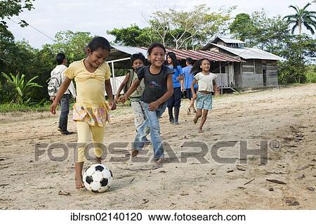 School children playing soccer in the schoolyard before classes start in a village with no road access in the rainforest of the Oriente, Curaray, Ecuador, South America View Large Photo Image Stock Image - School children playing soccer in the schoolyard before classes start in a village with no road access in the rainforest of the Oriente, Curaray, Ecuador, South America. Fotosearch