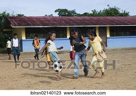 School children playing soccer in the schoolyard before classes start in a village with no road access in the rainforest of the Oriente, Curaray, Ecuador, South America View Large Photo Image Stock Image - School children playing soccer in the schoolyard before classes start in a village with no road access in the rainforest of the Oriente, Curaray, Ecuador, South America. Fotosearch