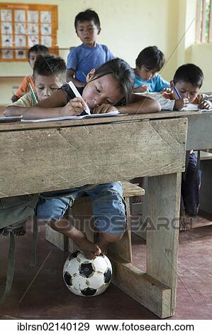 Schoolchildren learning to write in an elementary school in a village with no road access in the rainforest of the Oriente, Curaray, Ecuador, South America View Large Photo Image Stock Photo - Schoolchildren learning to write in an elementary school in a village with no road access in the rainforest of the Oriente, Curaray, Ecuador, South America. Fotosearch