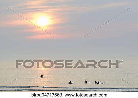 Silhouettes, surfers and sea kayaker on the calm North Sea in the evening, Norderney, East Frisian Islands, Lower Saxony, Germany, Europe View Large Photo Image Stock Image - Silhouettes, surfers and sea kayaker on the calm North Sea in the evening, Norderney, East Frisian Islands, Lower Saxony, Germany, Europe. Fotosearch