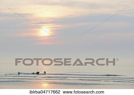 Silhouettes, surfers on the quiet North Sea in the evening, Norderney, East Frisian Islands, Lower Saxony, Germany, Europe View Large Photo Image Stock Image - Silhouettes, surfers on the quiet North Sea in the evening, Norderney, East Frisian Islands, Lower Saxony, Germany, Europe. Fotosearch