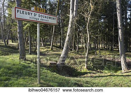 Stock Photo - Site of the destroyed village Fleury-devant-Douaumont, grenade funnel overgrown by forest, in front sign for warning, battlefield of Verdun, First World War, Verdun, Grand Est, France, Europe. Fotosearch