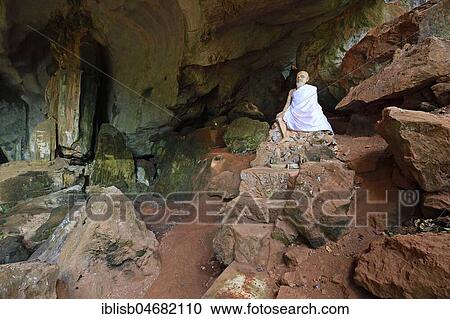 Stock Image - Sitting statue of a monk in the cave temple Wat Tham Suwan Khuha, Phang Nga, Thailand, Asia. Fotosearch
