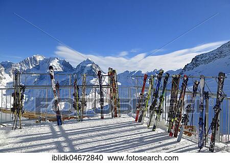 Stock Image - Ski parked in front of snowy mountain scenery, ski area Corvatsch, Piz Roseg in the background, Upper Engadine, Canton Graubünden, Switzerland, Europe. Fotosearch