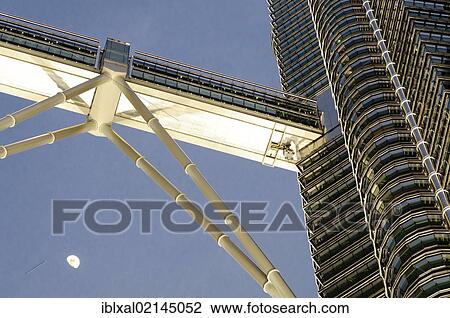 Stock Image - Skybridge, Petronas Towers at dusk with moon, Kuala Lumpur, Malaysia, Southeast Asia, Asia. Fotosearch