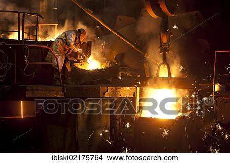 Smelter worker wearing protective equipment, employee of the Luitpoldhuette AG, a foundry that specializes in the casting of engine blocks, motor parts and refrigeration compressors, during the the slagging of the furnace, in Amberg, Bavaria, Germany,... View Large Photo Image Picture - Smelter worker wearing protective equipment, employee of the Luitpoldhuette AG, a foundry that specializes in the casting of engine blocks, motor parts and refrigeration compressors, during the the slagging of the furnace, in Amberg, Bavaria, Germany,.... Fotosearch