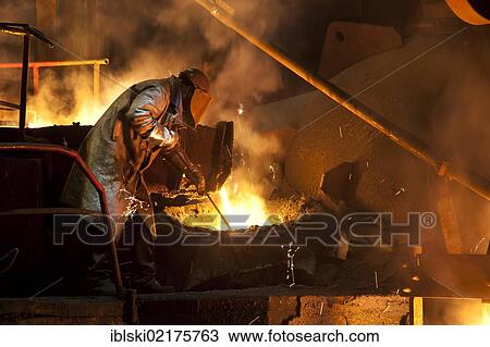 Smelter worker wearing protective equipment, employee of the Luitpoldhuette AG, a foundry that specializes in the casting of engine blocks, motor parts and refrigeration compressors, during the the slagging of the furnace, in Amberg, Bavaria, Germany,... View Large Photo Image Stock Image - Smelter worker wearing protective equipment, employee of the Luitpoldhuette AG, a foundry that specializes in the casting of engine blocks, motor parts and refrigeration compressors, during the the slagging of the furnace, in Amberg, Bavaria, Germany,.... Fotosearch