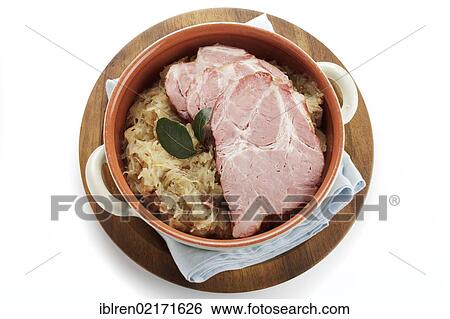 Stock Photograph - Smoked pork neck roast on sauerkraut, gammon, Kassel-style pork. Fotosearch