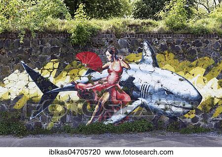 Spanish woman with fan sitting on a shark, mural by Carlo Alberto, Streetart, Rhine Side Gallery Uerdingen, Krefeld, NRW, Germany, Europe View Large Photo Image Stock Image - Spanish woman with fan sitting on a shark, mural by Carlo Alberto, Streetart, Rhine Side Gallery Uerdingen, Krefeld, NRW, Germany, Europe. Fotosearch