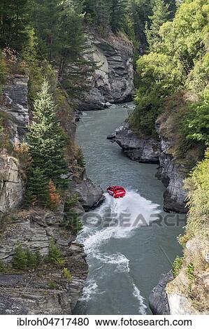 Stock Image - Speedboat in the Canyon of Shotover River, Queenstown, Otago, South Island, New Zealand, Oceania. Fotosearch