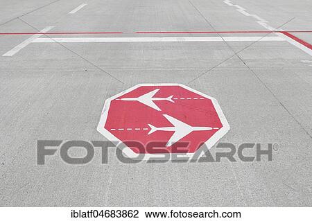 Stock Image - Stop sign, intersecting aircraft, on taxiway, Munich Airport, Upper Bavaria, Bavaria, Germany, Europe. Fotosearch