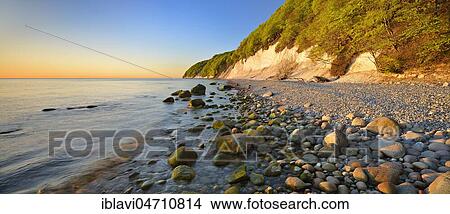 Sunrise at the Baltic Sea, chalk rocks in the morning light, boulders and pebbles on the shore, Jasmund National Park, Rügen Island, Mecklenburg-Western Pomerania, Germany, Europe View Large Photo Image Picture - Sunrise at the Baltic Sea, chalk rocks in the morning light, boulders and pebbles on the shore, Jasmund National Park, Rügen Island, Mecklenburg-Western Pomerania, Germany, Europe. Fotosearch
