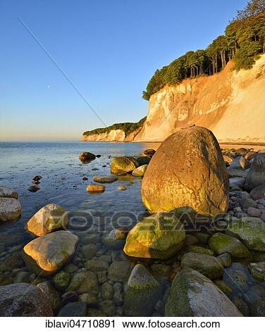 Sunrise on the shores of the Baltic Sea, large boulders, chalk cliffs of the cliffs in the morning light, Jasmund National Park, Rügen Island, Mecklenburg-Western Pomerania, Germany, Europe View Large Photo Image Stock Image - Sunrise on the shores of the Baltic Sea, large boulders, chalk cliffs of the cliffs in the morning light, Jasmund National Park, Rügen Island, Mecklenburg-Western Pomerania, Germany, Europe. Fotosearch