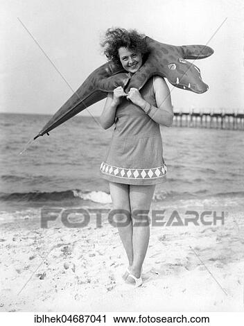 Swimwear, woman with swimsuit and inflatable crocodile on the beach, 1940s, Rügen, Baltic Sea, Germany, Europe View Large Photo Image Stock Image - Swimwear, woman with swimsuit and inflatable crocodile on the beach, 1940s, Rügen, Baltic Sea, Germany, Europe. Fotosearch