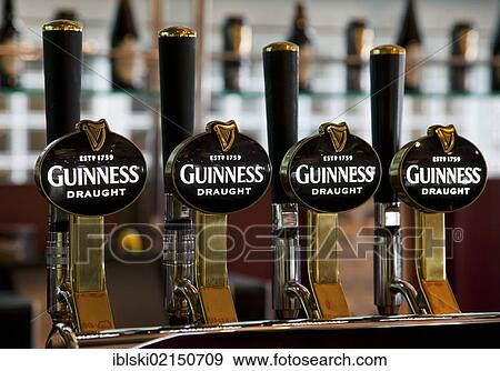 Taps with the Guinness logo in the Storehouse in the Guinness brewery, part of the Diageo drinks company, Dublin, Ireland, Europe View Large Photo Image Stock Photo - Taps with the Guinness logo in the Storehouse in the Guinness brewery, part of the Diageo drinks company, Dublin, Ireland, Europe. Fotosearch