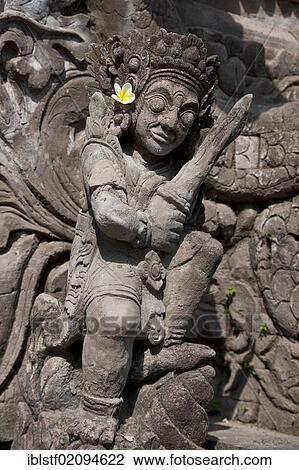 Temple figure holding a Kris sword and adorned with a blossom, Bura Beji Temple, Sangsit, North Bali, Bali, Indonesia, Southeast Asia, Asia View Large Photo Image Stock Image - Temple figure holding a Kris sword and adorned with a blossom, Bura Beji Temple, Sangsit, North Bali, Bali, Indonesia, Southeast Asia, Asia. Fotosearch