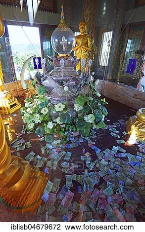 Stock Image - The Blessed Sacrament with banknotes as donations, Wat Chalong, largest temple of the island Phuket, Thailand, Asia. Fotosearch