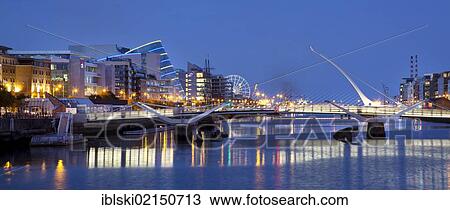 Stock Image - The Docklands, the former port area, with the Convention Centre Dublin and the Samuel Beckett Bridge by the architect Santiago Calatrava on the River Liffey in Dublin, Ireland, Europe. Fotosearch