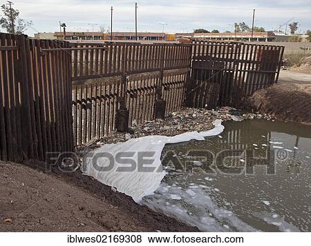 The heavily-polluted New River, as it enters the USA from Mexico, the pollution results from a mix of untreated sewage, agricultural runoff, and industrial waste; the barrier in the river prevents migrants from using the river to enter the United... View Large Photo Image Stock Photo - The heavily-polluted New River, as it enters the USA from Mexico, the pollution results from a mix of untreated sewage, agricultural runoff, and industrial waste; the barrier in the river prevents migrants from using the river to enter the United.... Fotosearch