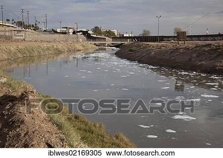 The heavily-polluted New River, as it enters the USA from Mexico, the pollution results from a mix of untreated sewage, agricultural runoff, and industrial waste; migrants sometimes try to use the river to enter the United States illegally, Calexico,... View Large Photo Image Stock Photography - The heavily-polluted New River, as it enters the USA from Mexico, the pollution results from a mix of untreated sewage, agricultural runoff, and industrial waste; migrants sometimes try to use the river to enter the United States illegally, Calexico,.... Fotosearch