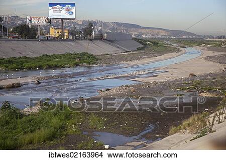 Picture - The polluted Tijuana River as it enters the United States from Mexico, San Ysidro, California, USA, North America. Fotosearch