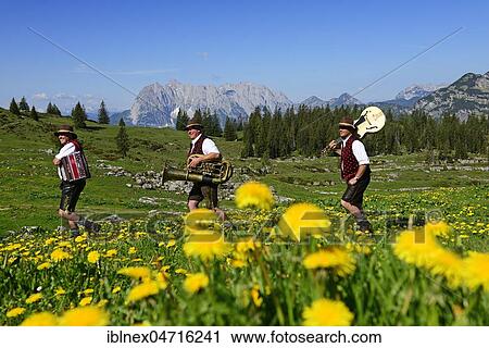 Three folk musicians with instruments, Bergfexn trio in traditional costume on the Eggenalm, behind Wilder Kaiser, Reit im Winkl, Bavaria, Germany, Europe View Large Photo Image Stock Image - Three folk musicians with instruments, Bergfexn trio in traditional costume on the Eggenalm, behind Wilder Kaiser, Reit im Winkl, Bavaria, Germany, Europe. Fotosearch