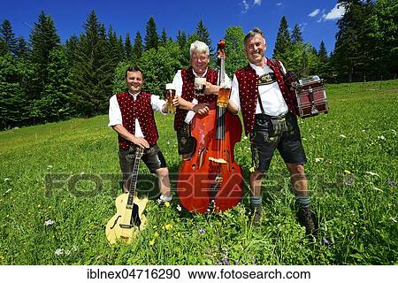 Three folk musicians with instruments and beer, Bergfexn trio in traditional costume on the Eggenalm, behind Wilder Kaiser, Reit im Winkl, Bavaria, Germany, Europe View Large Photo Image Stock Image - Three folk musicians with instruments and beer, Bergfexn trio in traditional costume on the Eggenalm, behind Wilder Kaiser, Reit im Winkl, Bavaria, Germany, Europe. Fotosearch