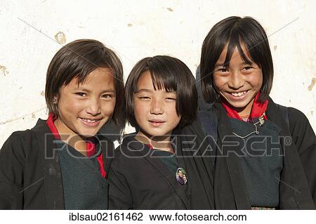 Three smiling girls, portrait, dressed in traditional costume in the village of Thinleygang near Punakha, the Himalayas, Kingdom of Bhutan, South Asia, Asia View Large Photo Image Stock Image - Three smiling girls, portrait, dressed in traditional costume in the village of Thinleygang near Punakha, the Himalayas, Kingdom of Bhutan, South Asia, Asia. Fotosearch