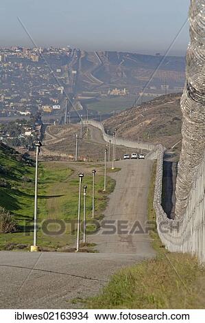 Three U. S. Border Patrol vehicles patrol the international border between the United States and Mexico, with the Border Patrol's new fence at right and Tijuana on the left, San Ysidro, California, USA, North America View Large Photo Image Picture - Three U. S. Border Patrol vehicles patrol the international border between the United States and Mexico, with the Border Patrol's new fence at right and Tijuana on the left, San Ysidro, California, USA, North America. Fotosearch