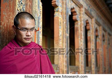 Tibetan Buddhism, monk in a red robe, ornate wooden wall, Tango Goemba Monastery, near Thimphu, the Himalayas, Kingdom of Bhutan, South Asia, Asia View Large Photo Image Stock Photo - Tibetan Buddhism, monk in a red robe, ornate wooden wall, Tango Goemba Monastery, near Thimphu, the Himalayas, Kingdom of Bhutan, South Asia, Asia. Fotosearch