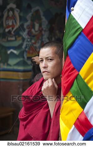 Tibetan Buddhism, monk wearing a red robe looking pensive, Rinpung Dzong Monastery and Fortress, Paro, Himalayas, Bhutan, South Asia, Asia View Large Photo Image Stock Photo - Tibetan Buddhism, monk wearing a red robe looking pensive, Rinpung Dzong Monastery and Fortress, Paro, Himalayas, Bhutan, South Asia, Asia. Fotosearch