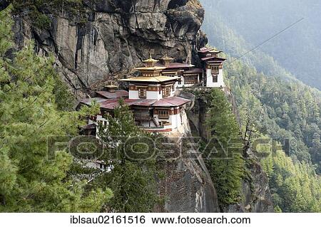 Stock Photograph - Tibetan Buddhism, Taktsang Palphug Monastery on a rock face, also known as The Tiger's Nest, near Paro, Himalayas, Bhutan, South Asia, Asia. Fotosearch