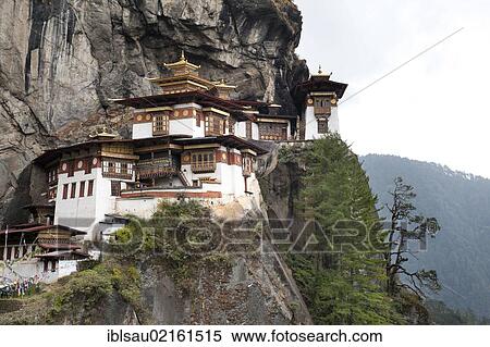 Stock Photography - Tibetan Buddhism, Taktsang Palphug Monastery on a rock face, also known as The Tiger's Nest, near Paro, Himalayas, Bhutan, South Asia, Asia. Fotosearch