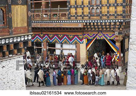 Tibetan Buddhist festival, people wearing the traditional Gho robe standing in a queue, Rinpung Dzong Monastery and Fortress, courtyard, Paro, Himalayas, Bhutan, South Asia, Asia View Large Photo Image Picture - Tibetan Buddhist festival, people wearing the traditional Gho robe standing in a queue, Rinpung Dzong Monastery and Fortress, courtyard, Paro, Himalayas, Bhutan, South Asia, Asia. Fotosearch