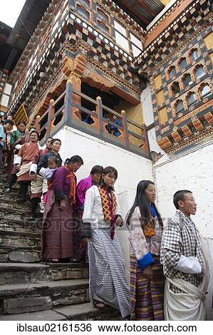 Tibetan Buddhist festival, people wearing the traditional Gho robe standing on a staircase in a queue, Rinpung Dzong Monastery and Fortress, courtyard, Paro, Himalayas, Bhutan, South Asia, Asia View Large Photo Image Stock Photograph - Tibetan Buddhist festival, people wearing the traditional Gho robe standing on a staircase in a queue, Rinpung Dzong Monastery and Fortress, courtyard, Paro, Himalayas, Bhutan, South Asia, Asia. Fotosearch