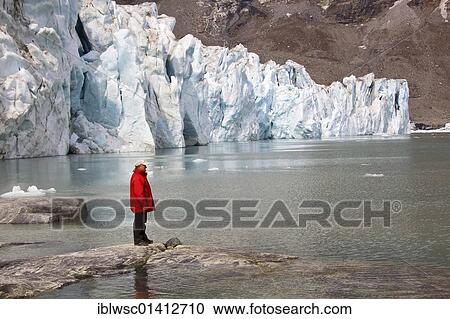Tourist with a red jacket in front of the Karale glacier, Sermiligaaq Fjord, East Greenland, Greenland, Denmark, North America View Large Photo Image Stock Image - Tourist with a red jacket in front of the Karale glacier, Sermiligaaq Fjord, East Greenland, Greenland, Denmark, North America. Fotosearch