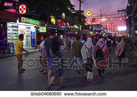 Tourists between bars, shops and restaurants on Bangla Road at dusk, party district and red light district, Patong Beach, Phuket, Thailand, Asia View Large Photo Image Stock Image - Tourists between bars, shops and restaurants on Bangla Road at dusk, party district and red light district, Patong Beach, Phuket, Thailand, Asia. Fotosearch